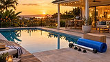 Heated backyard pool with a DIY solar kit ready to install beside it at sunset
