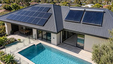 Aerial view of an Australian home with rooftop solar panels and a backyard pool, ready to use free midday power