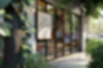 A trendy cafe surrounded by leafy greenery