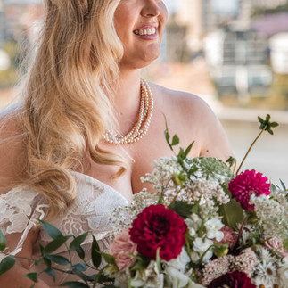 Beautiful bride holding red and white Australian native flower bouquet