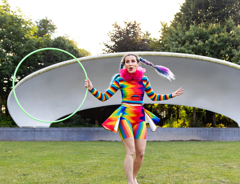 Female in colourful clothing performing show for neurodivergent children