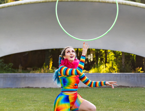 Moss Russell Neurodivergent artist balancing hula hoop