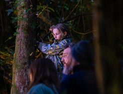 audience watching performance in forest