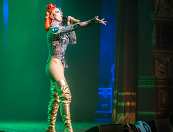 Drag Artist with red wig performing