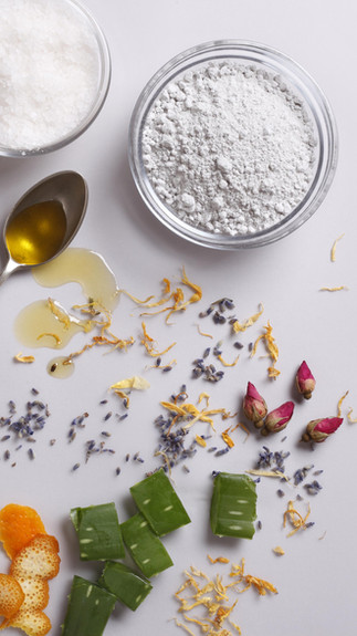 Natural skincare ingredients including aloe vera, botanical oils, sea salt and lemon for skin nourishment
