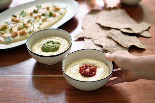 Bowls of hummus beautifully served on table