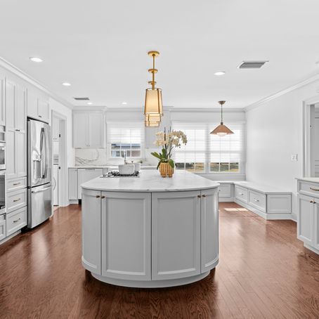 Beautiful Tampa, Florida kitchen remodel with white cabinets, marble countertops, and large kitchen island.