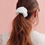 Thumbnail: Woman with long hair using a white cotton scrunchie as a ponytail