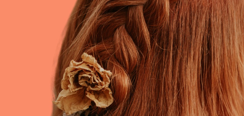Woman with medium length straight hairstyle with a half up braid