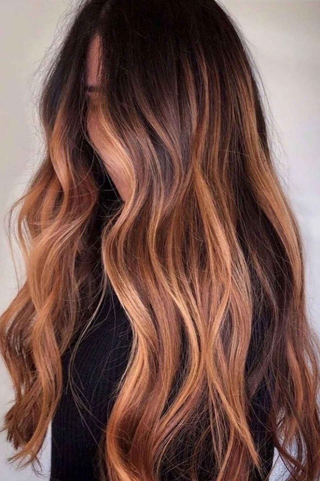 Long brunette hair from the side with hand painted copper balayage highlights