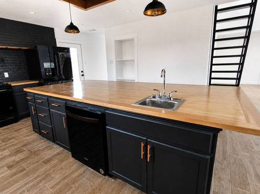 custom kitchen with black cabinetry and wood countertops restoration work in Aledo, Texas