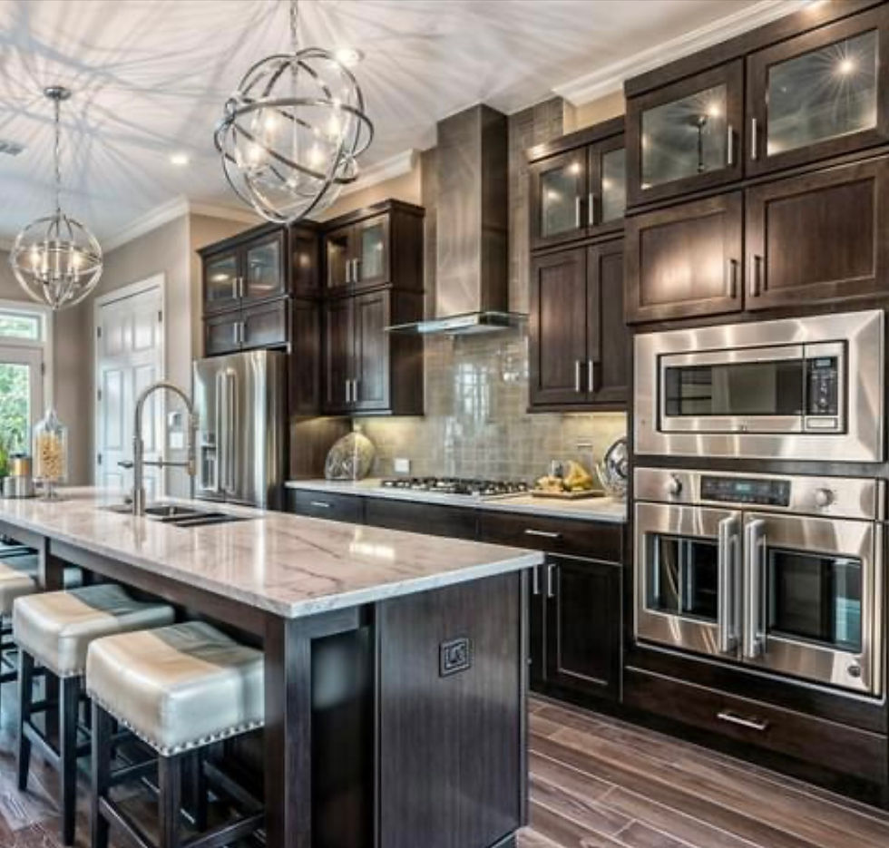 Kitchen remodel showing custom cabinets, new appliances, and a large island with sink