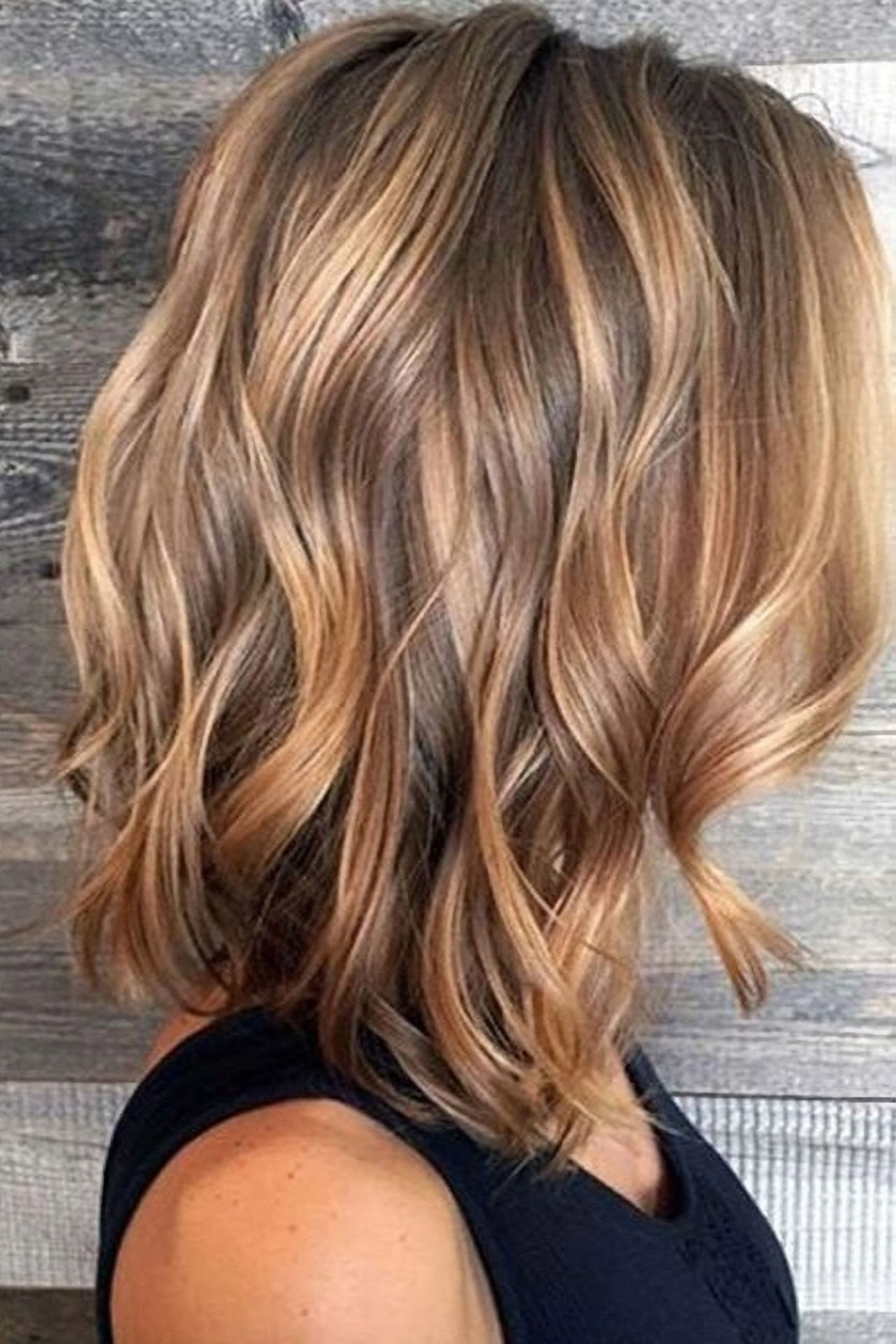 Bobbed hair curled with hand painted blonde balayage highlights