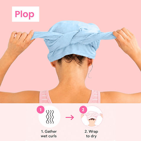 Woman using a blue t-shirt hair towel to plop curly hair