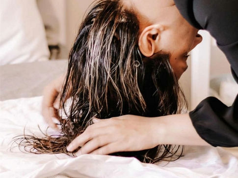 woman plopping curly hair using a t-shirt hair towel for defined frizz-free curls