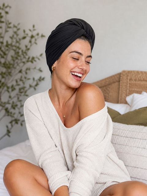 woman stylishly posing in a black t-shirt hair towel