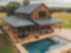 Large country cabin style barndo with a wraparound porch and pool