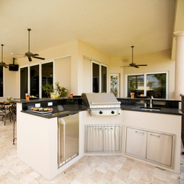 Outdoor living area with kitchen and grill