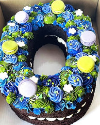 Custom cake for all occasions, blue & green frosting, macarons.