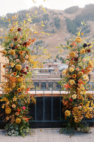 Fall inspired wedding arch at private balcony overlooking Aspen Mountain