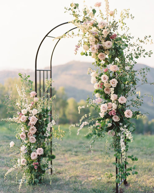 Fairy garden flower arch on rounded metal structure with views of the mountains