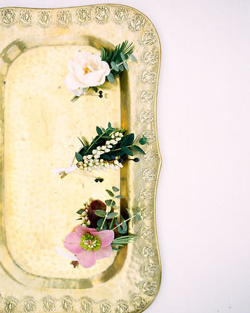 Textured boutonnieres on gold tray