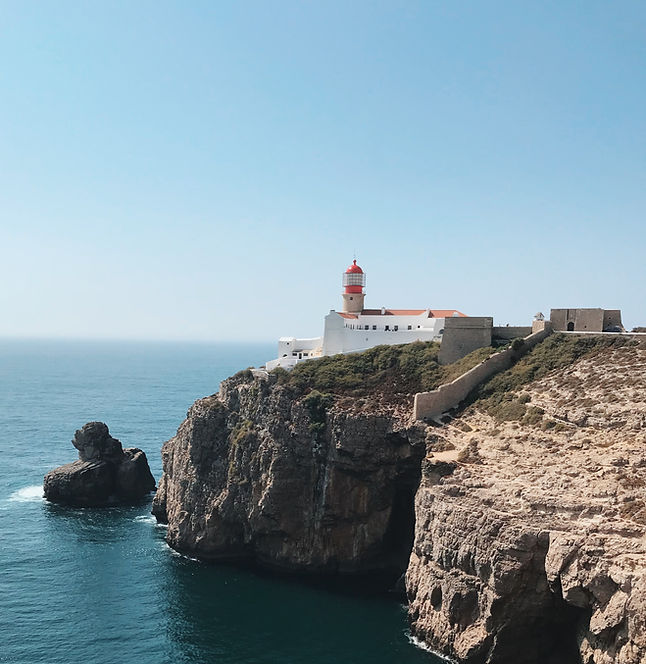 white and orange building beside seashore during daytime_edited.jpg