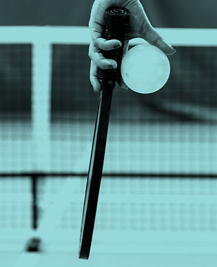a person holding a tennis ball and a rac
