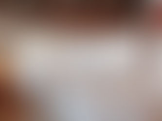 Inside rustic reception room of a wedding venue with white linens, white chairs, rustic decor, string lights at a wedding venue near Houston, Texas.