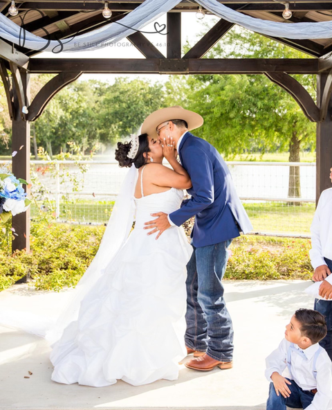 Outdoor wedding venue gazebo with water feature backdrop and garden ceremony area at a wedding venue near El Campo, Texas.