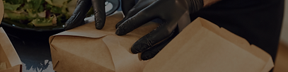 black-gloves-man-is-packing-food-into-paper-eco-boxes-indoors-restaurant.png