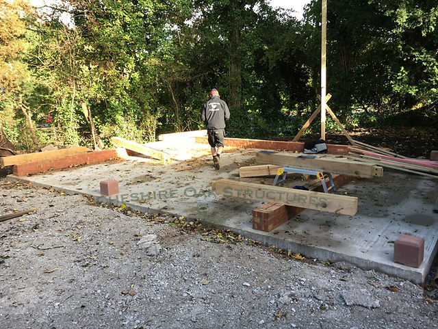 Oak Post being installed for two bay Oak garage frame