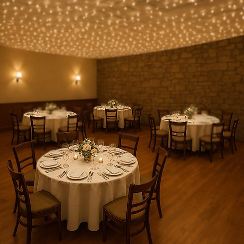 A cozy banquet room with polished wood floors and six round tables arranged evenly through