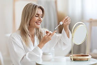 Stock woman applying serum