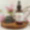Magnesium oil on display with flowers behind spray bottle