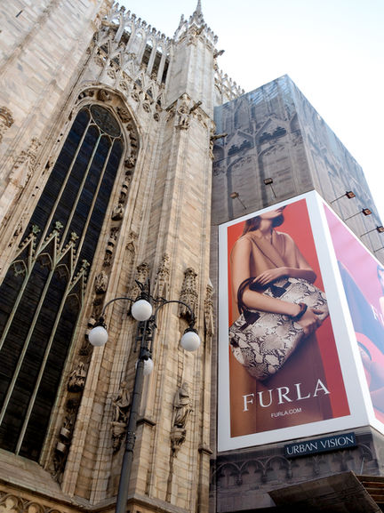 Gothic building with Furla advertisement banner.