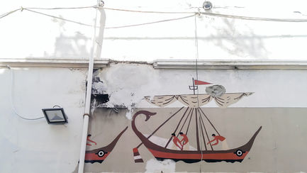 Viking ship mural on a snow-covered wall.