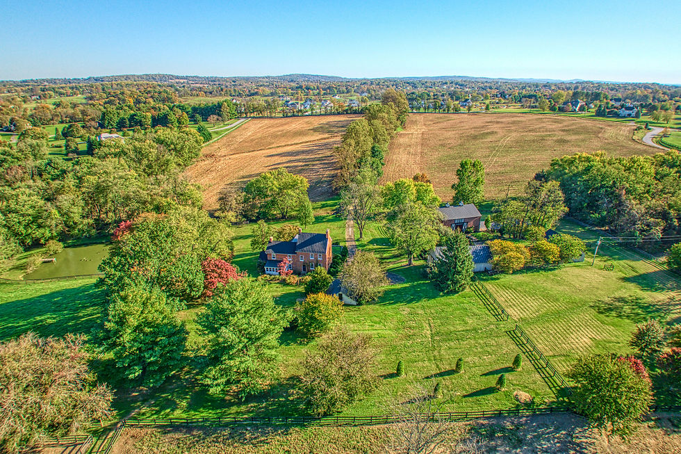 An aerial view of The William Smith House and its nearly 40 acres in the heart of the Loudoun Valley — farmhouse, restored barn, pond, and paddocks as they have stood since 1813. 38678 Piggott Bottom Road, Hamilton, Virginia.