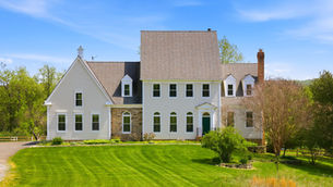 Front exterior of 15018 Clover Hill Road, Waterford VA — a white clapboard colonial with stone accents on approx. 10 acres.