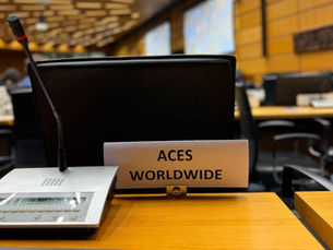 ACES Worldwide nameplate at a delegate desk with a microphone in the UNCOPUOS conference hall