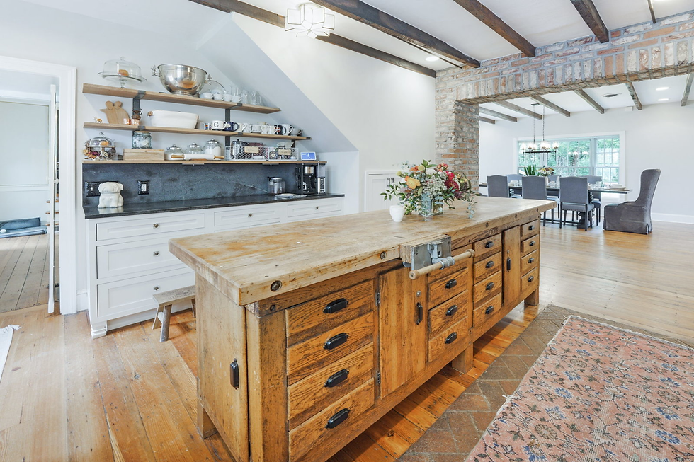 Historic home for sale near Charles Town. This picture of the kitchen features a giant wood island.
