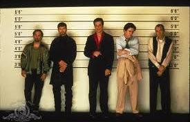 Movie poster for the 1995 film The Usual Suspects, featuring five men standing in a police lineup against a white wall.