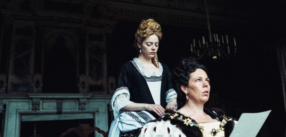 Abigail (Emma Stone) aids Anne (Olivia Colman) in The Favourite