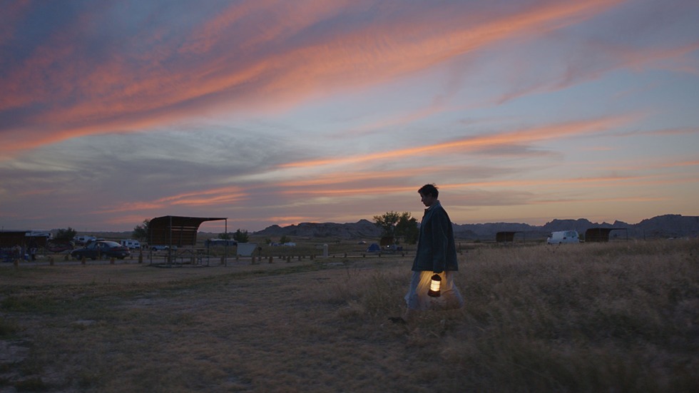 Fern (Frances McDormand) walking under a gorgeous sky - from Nomadland