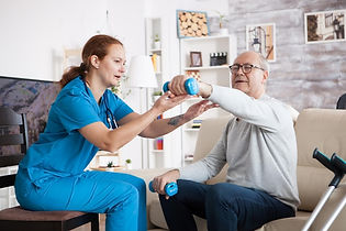 senior-man-nursing-home-with-doing-physical-therapy-with-help-from-nurse-using-dumbbells.j