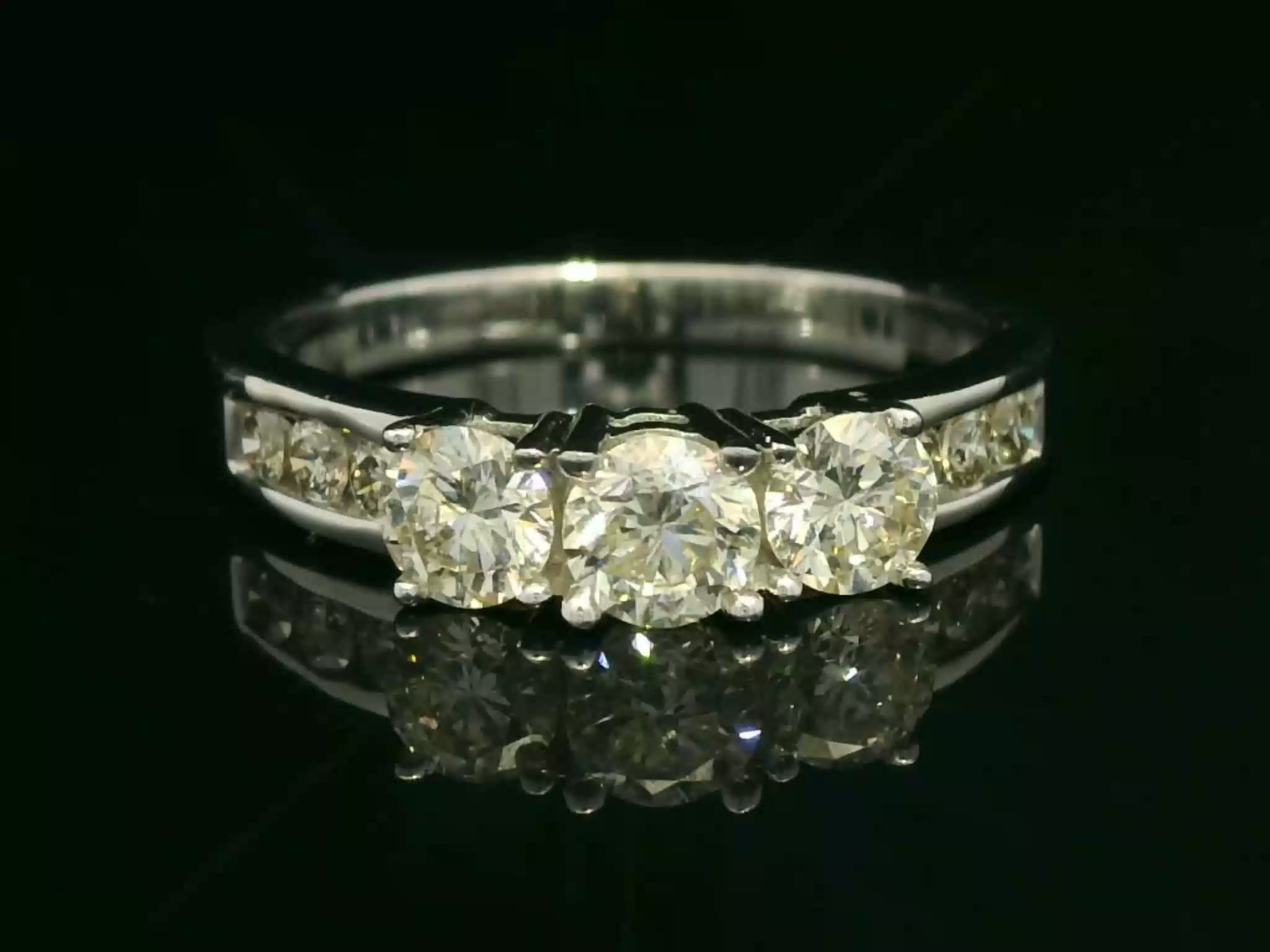 Three-Stone Round Brilliant Cut Diamond White Gold Channel-Set Ring