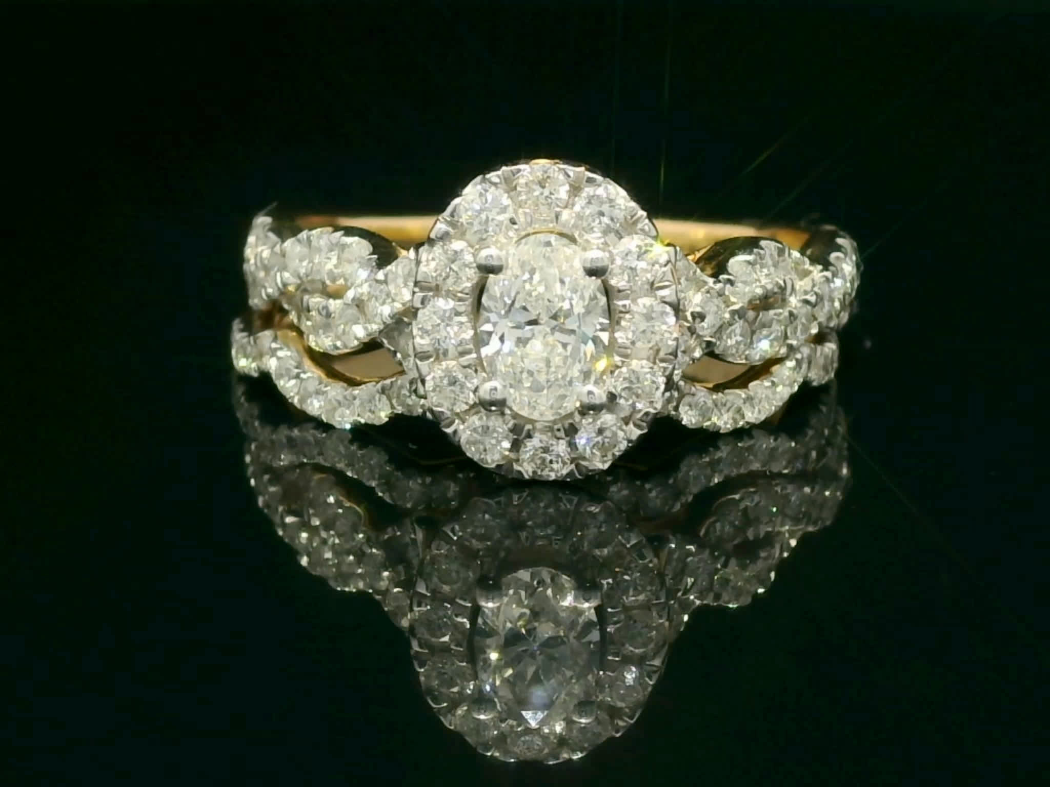 Oval Brilliant Diamond Halo Engagement Ring in Interlocking Pavé Yellow Gold