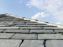 A slate tiled roof. on a traditional ho