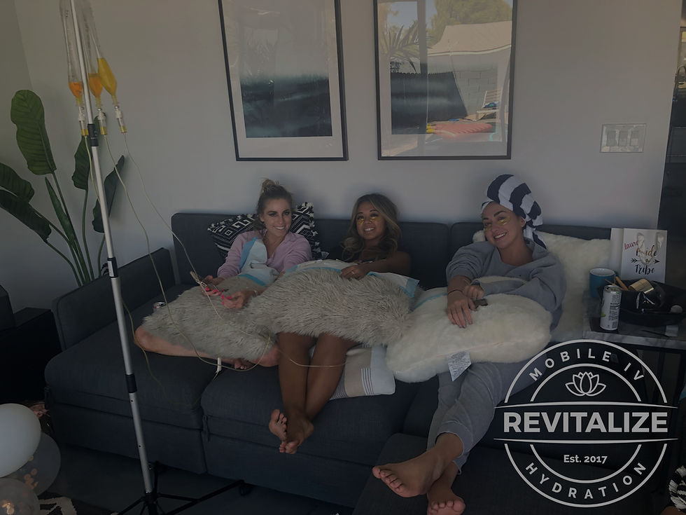 Three people receive a rejuvenating IV hydration session at home.