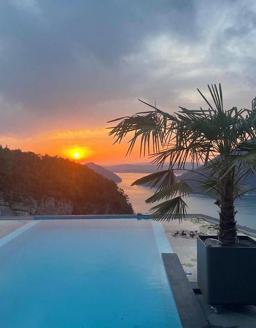 Villa Tauris Natural Pool at sunset above Lake Lucerne in Emmetten, Switzerland